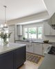 Modern home with Kitchen, Quartzite Counter, Wood Cabinet, Stone Counter, Colorful Cabinet, Light Hardwood Floor, Subway Tile Backsplashe, Marble Backsplashe, Pendant Lighting, Range, Range Hood, and Undermount Sink. The custom cabinets are a soothing gray (Harbor Gray by Benjamin Moore) and present a bright look without being stark white. The walls are painted in Cloud Cover by Benjamin Moore. The floor is European white oak in 7¼-inch planks with a custom finish. Photo 2 of Happy Valley Remodel