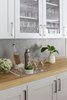 Modern home with Kitchen, Wood Counter, and Colorful Cabinet. The custom cabinetry and self-closing drawers hide a pullout charging station and liquor drawers. The cabinet pulls: Trinity by Emtek Photo 4 of Happy Valley Remodel