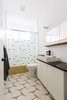 Modern home with Bath Room, Vessel Sink, Wood Counter, Drop In Tub, Ceramic Tile Floor, and Wall Lighting. Bathrooms include cement tile by Cle, and salvaged tubs from a local building material re-sale store. Photo 5 of Dorgenois