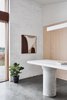 Modern home with Kitchen, Stone Counter, Concrete Floor, Wood Cabinet, Ceiling Lighting, Ceramic Tile Backsplashe, Accent Lighting, and Pendant Lighting. Kitchen featuring recycled concrete bollard as bench support. Art by Australian artists Hannah Nowlan (represented by Modern Times) Photo 8 of The 10 Star Home