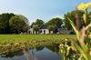 Modern home with Exterior, Tile Roof Material, House Building Type, Metal Siding Material, Wood Siding Material, and Brick Siding Material. Barnhouse blends in Photo 2 of Villa Hindeloopen