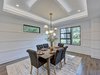 Modern home with Dining Room, Table, Chair, Recessed Lighting, Ceiling Lighting, Medium Hardwood Floor, and Accent Lighting. The dining room with modern wainscotting with tray ceiling with LED uplighting Photo 4 of Contemporary Craftsman Home