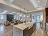 Modern home with Kitchen, Wood Cabinet, Light Hardwood Floor, Accent Lighting, Undermount Sink, Engineered Quartz Counter, Glass Tile Backsplashe, and Ceiling Lighting. Open floorplan Photo 7 of Contemporary Craftsman Home