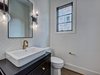 Modern home with Bath Room, Light Hardwood Floor, One Piece Toilet, Ceramic Tile Wall, and Vessel Sink. Powder room with accent wall Photo 12 of Contemporary Craftsman Home