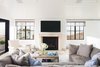 Modern home with Living Room, Sectional, Ceiling Lighting, Light Hardwood Floor, and Standard Layout Fireplace. Looking west, this home catches a glimpse of the Manhattan Beach shoreline, through the traditional steel windows. Photo 2 of Manhattan Ave Residence
