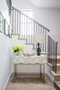 Modern home with Staircase, Wood Tread, and Metal Railing. The entry showcases a rustic reclaimed wood staircase, with simple steel uprights. Photo 8 of Manhattan Ave Residence