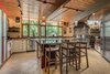 Modern home with Kitchen, Granite Counter, Porcelain Tile Backsplashe, White Cabinet, Ceramic Tile Floor, Track Lighting, Ceiling Lighting, Pendant Lighting, Refrigerator, Range Hood, Range, Microwave, Dishwasher, and Drop In Sink. Kitchen Photo 9 of Beautifully Designed Contemporary