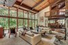 Modern home with Living Room, Sofa, Recliner, Chair, End Tables, Track Lighting, Bookcase, Coffee Tables, Ceiling Lighting, Accent Lighting, Medium Hardwood Floor, and Wood Burning Fireplace. Living Room Photo 5 of Beautifully Designed Contemporary