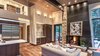 Modern home with Living Room, Ceiling Lighting, Recessed Lighting, Wall Lighting, Pendant Lighting, Gas Burning Fireplace, Medium Hardwood Floor, and Accent Lighting. Main Floor Photo 11 of Beaver Dam Luxury