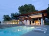 Modern home with Metal, Outdoor, Recliner, Small Pools, Tubs, Shower, Large Pools, Tubs, Shower, Swimming Pools, Tubs, Shower, Small Patio, Porch, Deck, Hanging Lighting, Large Patio, Porch, Deck, and Decking Patio, Porch, Deck. The bedroom volume slides under the large porch roof made of stucco, steel and IPE. Photo 4 of A Summer House