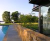Modern home with Outdoor, Garden, Back Yard, Small Pools, Tubs, Shower, Large Pools, Tubs, Shower, Plunge Pools, Tubs, Shower, Small Patio, Porch, Deck, Swimming Pools, Tubs, Shower, Decking Patio, Porch, Deck, Large Patio, Porch, Deck, Hardscapes, Gardens, and Walkways. The pool house is nestled around an existing stone wall that directs the view out toward the river. Photo 5 of A Summer House