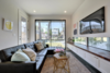 Modern home with Living Room, Chair, Bench, Ottomans, Coffee Tables, Sofa, End Tables, Sectional, Console Tables, Recessed Lighting, Ceiling Lighting, Floor Lighting, Dark Hardwood Floor, Table Lighting, and Track Lighting. Living Room Photo 6 of Johanna