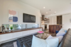 Modern home with Living Room, Bench, Ottomans, End Tables, Sofa, Chair, Sectional, Coffee Tables, Ceiling Lighting, Floor Lighting, Console Tables, Table Lighting, Track Lighting, Dark Hardwood Floor, and Recessed Lighting. Living Room Photo 7 of Johanna