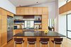 Modern home with Kitchen, Granite Counter, Wood Cabinet, Light Hardwood Floor, Glass Tile Backsplashe, Refrigerator, Range, Range Hood, Recessed Lighting, Ceiling Lighting, Microwave, and Undermount Sink. kitchen Photo 6 of Westlake2