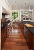 Modern home with Kitchen, Granite Counter, White Cabinet, Wood Counter, Wood Cabinet, Medium Hardwood Floor, Pendant Lighting, Recessed Lighting, Glass Tile Backsplashe, Range Hood, Range, Dishwasher, and Undermount Sink. kitchen Photo 3 of Westlake3