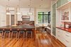 Modern home with Granite Counter, Wood Counter, Wood Cabinet, White Cabinet, Medium Hardwood Floor, Glass Tile Backsplashe, Recessed Lighting, Pendant Lighting, Range Hood, Range, Dining Room, Undermount Sink, Bench, Table, and Storage. kitchen Photo 4 of Westlake3