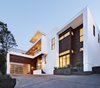 Modern home with Front Yard, Trees, Slope, Shrubs, Hardscapes, Raised Planters, Garage, and Attached Garage Room Type. exterior Photo of Westlake4