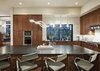 Modern home with Granite Counter, Wood Cabinet, Light Hardwood Floor, Marble Backsplashe, Pendant Lighting, Wall Oven, Range Hood, Recessed Lighting, Dishwasher, Microwave, Cooktops, Undermount Sink, Accent Lighting, Dining Room, Stools, Bar, and Storage. kitchen Photo 7 of Westlake4