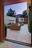 Modern home with Outdoor, Back Yard, Garden, Shrubs, Hardscapes, Gardens, Walkways, Concrete Pools, Tubs, Shower, Small Pools, Tubs, Shower, Large Patio, Porch, Deck, Stone Patio, Porch, Deck, Concrete Patio, Porch, Deck, Landscape Lighting, and Horizontal Fences, Wall. living room access Photo 2 of Mueller 1