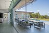 Modern home with Windows, Sliding Window Type, Picture Window Type, and Metal. main public wing looking west over the outdoor living area, featuring the floor to ceiling glass and visual/physical connection between interior and exterior space. Photo 5 of The U V House