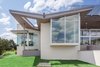 Modern home with Exterior, Metal Roof Material, House, Mid-Century Building Type, Stucco Siding Material, Stone Siding Material, and Butterfly RoofLine. exterior of the master wing featuring the cantilevered sitting bay, and roof hole over the master bath garden Photo 12 of The U V House