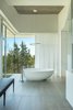 Modern home with Bath Room, Engineered Quartz Counter, Ceramic Tile Floor, Ceiling Lighting, Pendant Lighting, Ceramic Tile Wall, Freestanding Tub, Corner Shower, and Stone Tile Wall. master bath detail featuring the freestanding soaking tub Photo 14 of The U V House