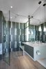 Modern home with Bath Room, Engineered Quartz Counter, Ceramic Tile Floor, Undermount Sink, Enclosed Shower, Pendant Lighting, Ceiling Lighting, Ceramic Tile Wall, and Stone Tile Wall. guest master bathroom featuring the roll in shower and floating counter top bench Photo 17 of The U V House