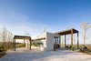 This project by Studio Saxe elegantly combines modern methods of construction with local materials and techniques. Villa Saxo is defined by an exoskeleton pergola structure that provides shade over large terraced areas while also creating a frame for the local flora to grow around. Photo 19 of Villa Saxo modern home