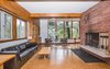 Modern home with Living Room, Bench, Bookcase, Sofa, Ceiling Lighting, Track Lighting, Accent Lighting, Wood Burning Fireplace, and Cork Floor. Living Room Photo 5 of Classic Mid Century Modern home for sale