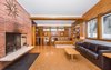 Modern home with Living Room, Bookcase, Ceiling Lighting, Track Lighting, Accent Lighting, Bench, Cork Floor, and Wood Burning Fireplace. Living Room Photo 6 of Classic Mid Century Modern home for sale