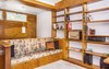 Modern home with Living Room, Bookcase, Track Lighting, Accent Lighting, Bench, Wood Burning Fireplace, Table Lighting, and Cork Floor. Living Room - original built-ins throughout Photo 8 of Classic Mid Century Modern home for sale
