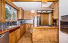Modern home with Kitchen, Wood Counter, Cork Floor, Track Lighting, Pendant Lighting, Accent Lighting, Ceiling Lighting, Wood Cabinet, Refrigerator, Dishwasher, Wall Oven, Range Hood, Undermount Sink, Drop In Sink, Range, and Metal Backsplashe. Custom Birch Kitchen Photo 12 of Classic Mid Century Modern home for sale
