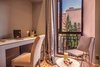 Modern home with Bedroom, Limestone Floor, Dresser, Chair, Pendant Lighting, Night Stands, Wardrobe, Travertine Floor, Ceiling Lighting, and Ceramic Tile Floor. loftsuite royalriad Marrakech Photo 6 of Riad Privilege Marrakech