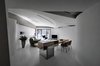 Modern home with Living Room, Bar, Table, Chair, Sofa, Wall Lighting, Ceiling Lighting, Lamps, and Concrete Floor. When entering the house, one could easily perceive its fluidity at the first glance. Photo of Fluid House