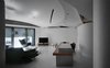 Modern home with Living Room, Chair, Sofa, Bar, Table, Lamps, Ceiling Lighting, Wall Lighting, and Concrete Floor. The ceiling is a composite of several curved surfaces, the seams of which implicitly implying the activities underneath. Photo 2 of Fluid House