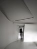 Modern home with Interior, Living Room, Concrete Floor, and Ceiling Lighting. After passing an in-between turning defined by two curved partitions, one enters the private area that contains a bedroom, a bathroom and a walk-in closet. Photo 6 of Fluid House