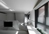 Modern home with Concrete Floor, Storage, Wardrobe, Bath Room, Marble Floor, Vessel Sink, Open Shower, Freestanding Tub, Ceiling Lighting, Marble Wall, and Two Piece Toilet. The space here still emphasizes its continuity but in an orthogonal order. The ceiling undulates up and down with the heights distributing different activities. Photo 7 of Fluid House