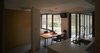 Modern home with Kitchen, Engineered Quartz Counter, Wood Cabinet, Drop In Sink, Ceramic Tile Floor, and Ceiling Lighting. The public space including a living room, kitchen, dining room as well as a guest room were arranged on the first floor. Photo 10 of Simple House