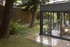 Modern home with Dining Room, Chair, Table, Pendant Lighting, and Ceramic Tile Floor. The dining room in the backyard that adopted the idea of "A Green House" was glazed in all surrounding walls and brought joy into the dining environment as if it were in the exterior garden. Photo 13 of Simple House