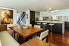 Modern home with Kitchen, Engineered Quartz Counter, White Cabinet, Medium Hardwood Floor, Dark Hardwood Floor, Metal Backsplashe, Mirror Backsplashe, Recessed Lighting, Ceiling Lighting, and Wall Oven. Kitchen Photo 4 of Hemlock Hill