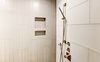 Modern home with Bath Room, Corner Shower, Enclosed Shower, Recessed Lighting, Glass Tile Wall, Ceiling Lighting, and Ceramic Tile Wall. The master bathroom floor tiles is also carried vertically on the end walls and in the shower. Photo 7 of Modern Infusions