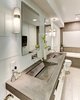 Modern home with Bath Room, Concrete Counter, Drop In Sink, Ceramic Tile Floor, Alcove Tub, Ceiling Lighting, Wall Lighting, Glass Tile Wall, One Piece Toilet, Ceramic Tile Wall, and Recessed Lighting. The master bathroom features a custom concrete countertop with integrated trough sinks. Photo 6 of Modern Infusions