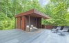 Modern home with Rooftop, Metal Patio, Porch, Deck, Stone Patio, Porch, Deck, Metal Fences, Wall, Exterior, Metal Roof Material, and Metal Siding Material. 'Tree House' - Terrace Photo 2 of Mountain House Modern