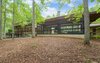 Modern home with Large Patio, Porch, Deck, Wood Patio, Porch, Deck, Concrete Patio, Porch, Deck, Exterior, House Building Type, Concrete Siding Material, Wood Siding Material, and Stucco Siding Material. 'Mountain House' - Screened Porch Side View Photo 4 of Mountain House Modern