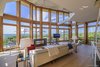 Modern home with Living Room, Chair, Sofa, Recliner, Ottomans, End Tables, Ceiling Lighting, Coffee Tables, Accent Lighting, Gas Burning Fireplace, and Light Hardwood Floor. Living room with exposed cedar columns and gas-powered fireplace Photo 5 of Amagansett Beach House