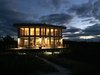 Modern home with Outdoor, Wood Patio, Porch, Deck, Trees, Grass, Large Patio, Porch, Deck, Gardens, Hanging Lighting, and Walkways. Illuminated waterside interior reflecting warm wood finishes with under deck lighting for floating effect. Dark sky light fixtures and overhang eliminate light pollution. Photo of Amagansett Beach House