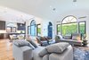 Modern home with Living Room, Chair, Table Lighting, Ceiling Lighting, Sofa, Coffee Tables, Recessed Lighting, Accent Lighting, Light Hardwood Floor, Gas Burning Fireplace, and Standard Layout Fireplace. Living Room Photo 3 of West Hollywood Tudor