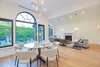 Modern home with Dining Room, Chair, Table, Ceiling Lighting, Table Lighting, Wall Lighting, Accent Lighting, Recessed Lighting, Standard Layout Fireplace, Light Hardwood Floor, and Gas Burning Fireplace. Dining Room Photo 4 of West Hollywood Tudor