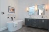 Modern home with Bath Room, Recessed Lighting, One Piece Toilet, Marble Wall, Wall Lighting, Corner Shower, Freestanding Tub, Undermount Sink, Marble Counter, and Porcelain Tile Floor. Master Bathroom Photo 10 of West Hollywood Tudor