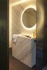 Modern home with Bath Room, Wall Mount Sink, Stone Counter, and One Piece Toilet. Many modern bathroom vanities use marble to elevate the style while keeping things elegant. The marble vanity seen here blends seamlessly into the marble wall behind it. Meanwhile, a striking illuminated mirror adds visual interest. Photo 15 of Rock'n Roll